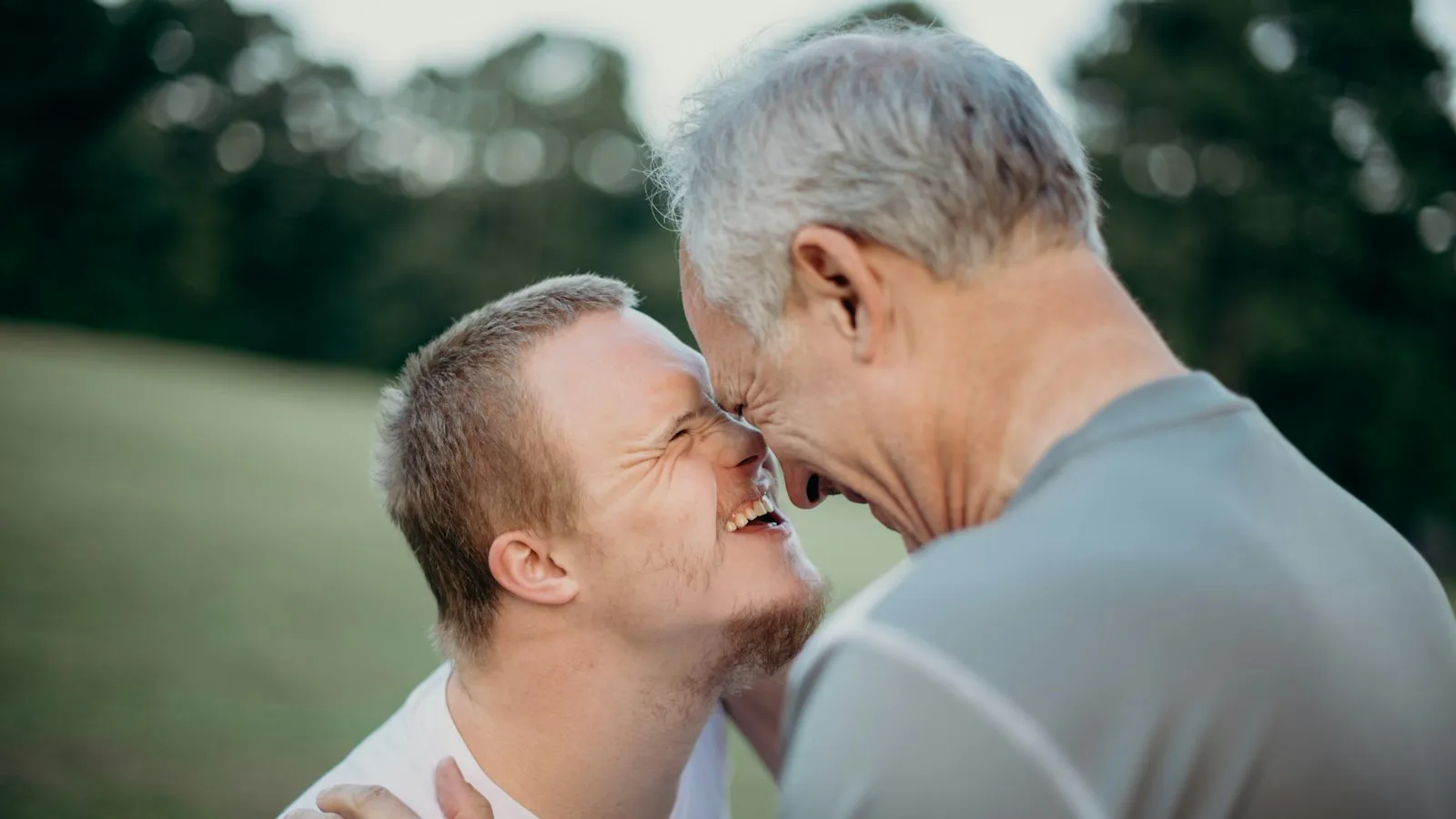 Two men talking on an open field
