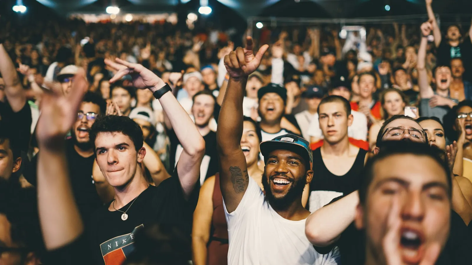A crowd cheering at a concert