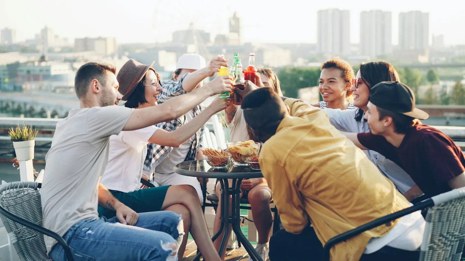Friends toasting drinks at a rooftop party