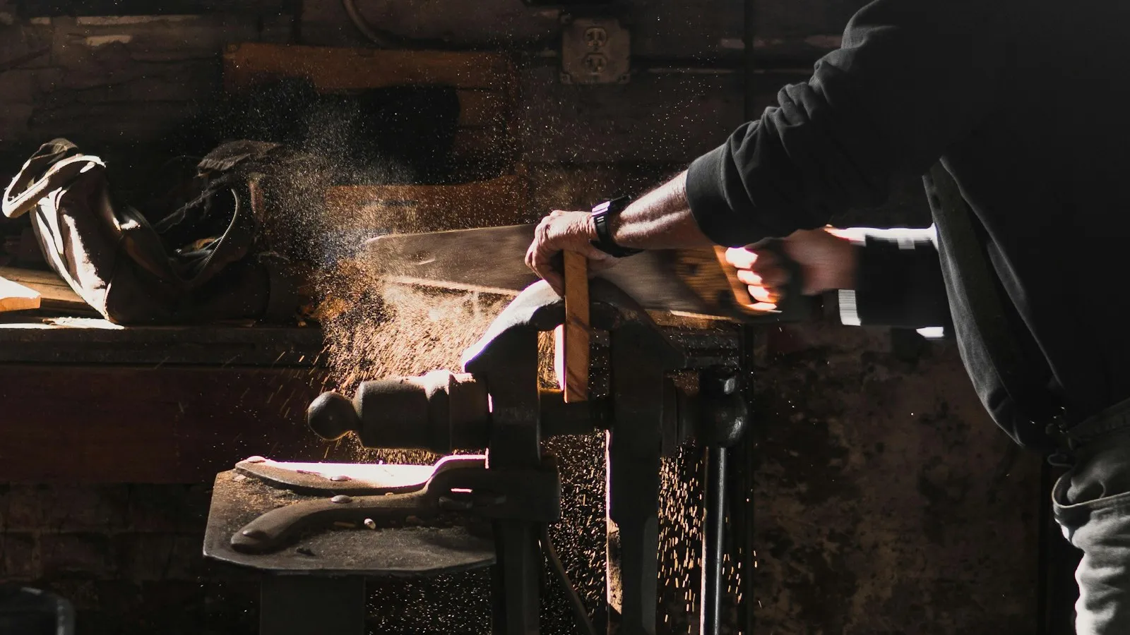 A man sawing wood in a workshop