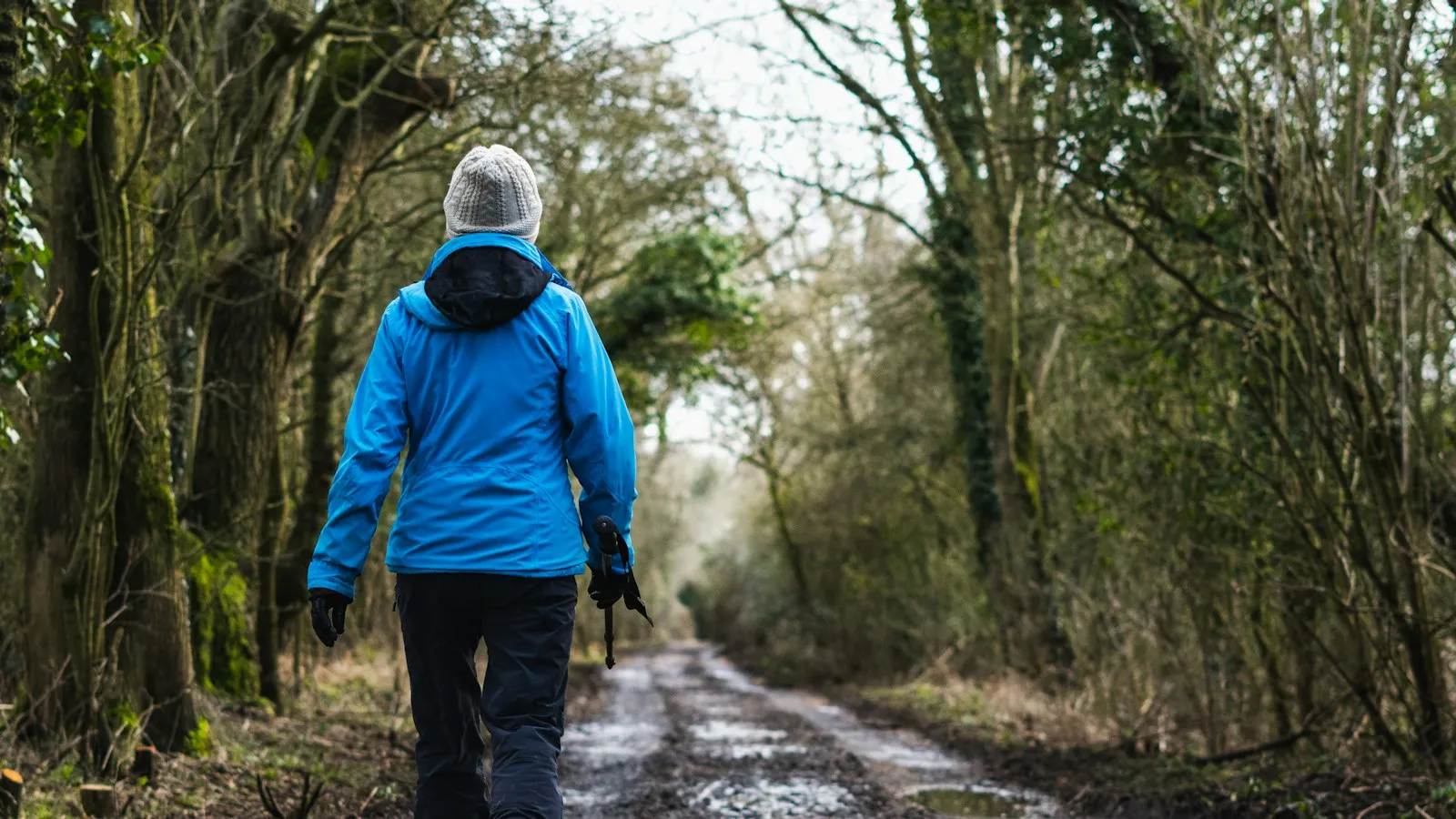 A person walking alone down a dirt road