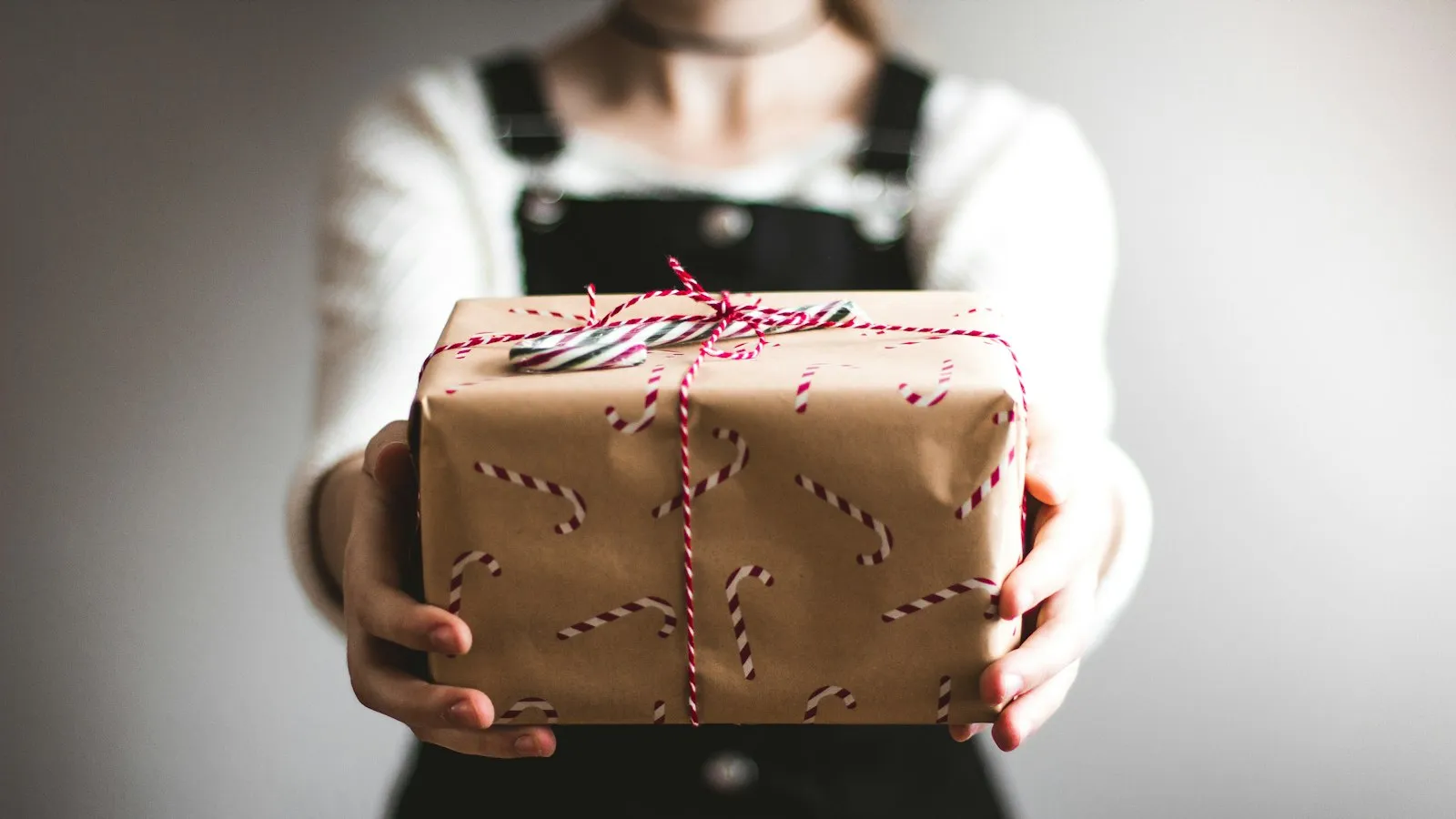 Someone holding out a small gift box