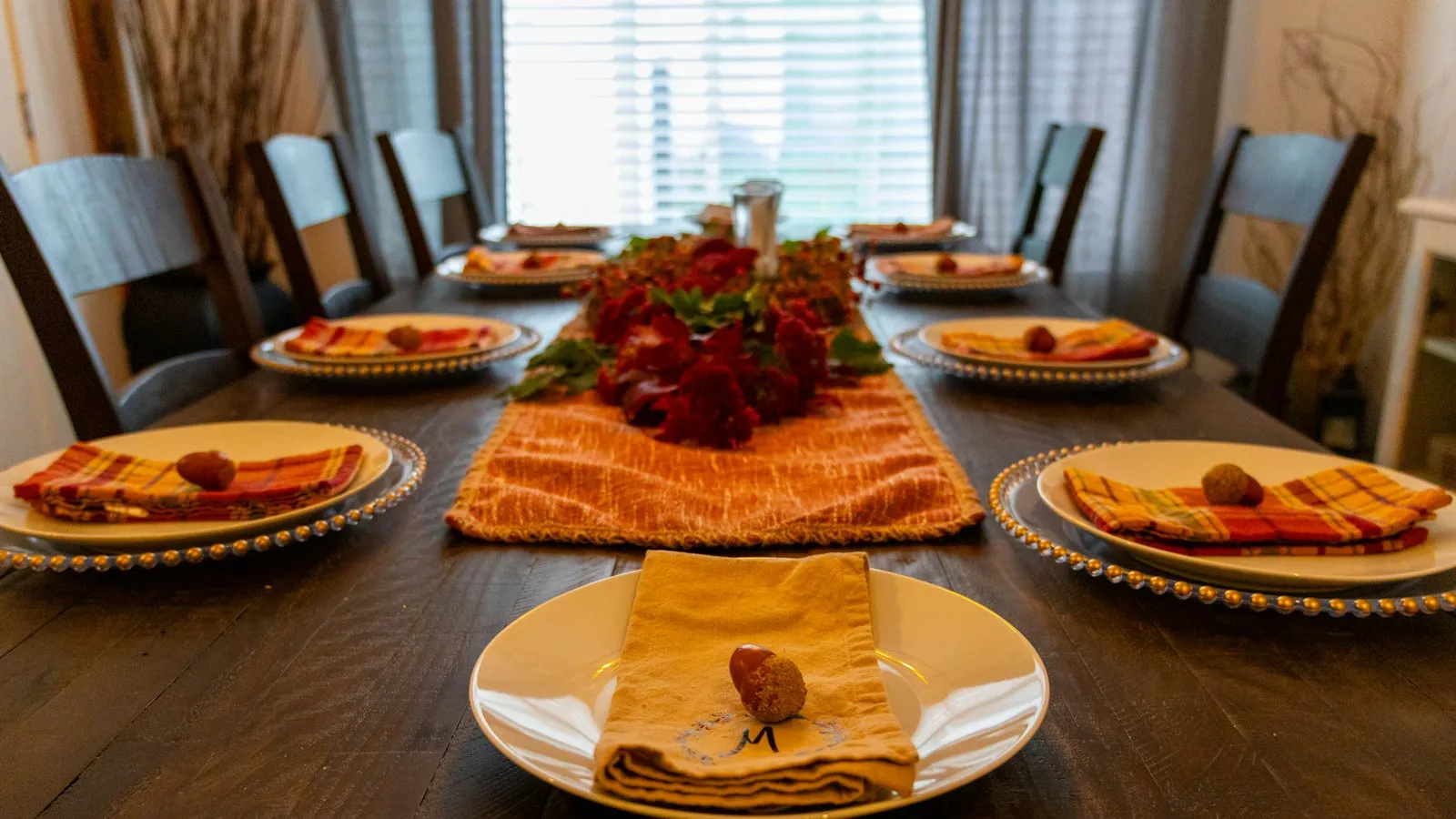 A dining table set with plates of holiday food