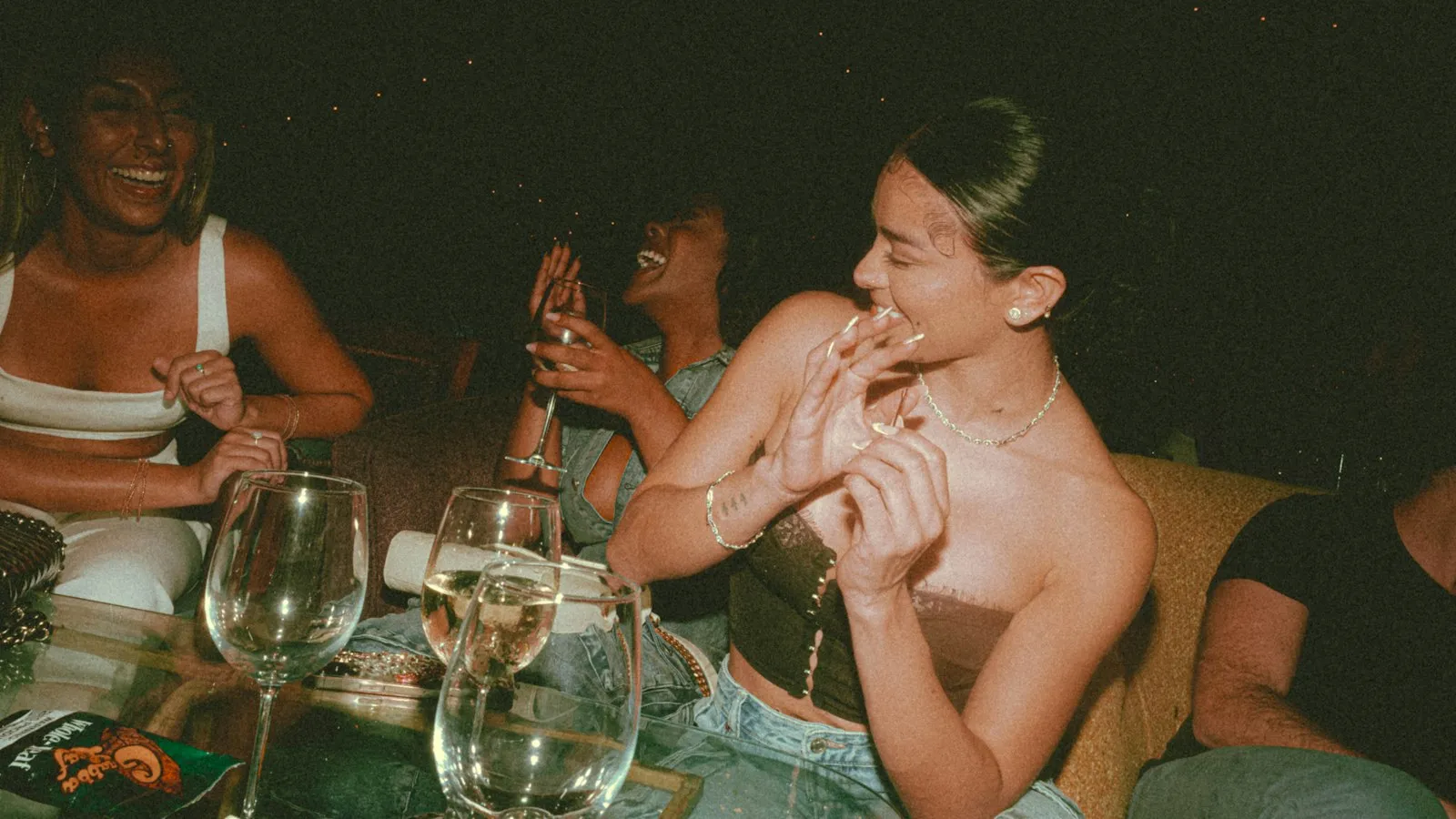 Friends sharing wine around a dinner table