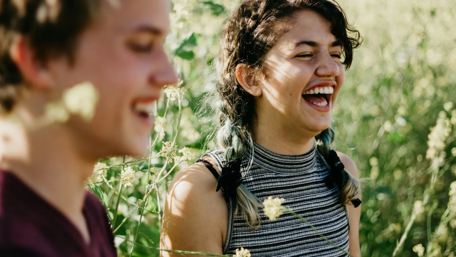 A brother and sister laughing outdoors